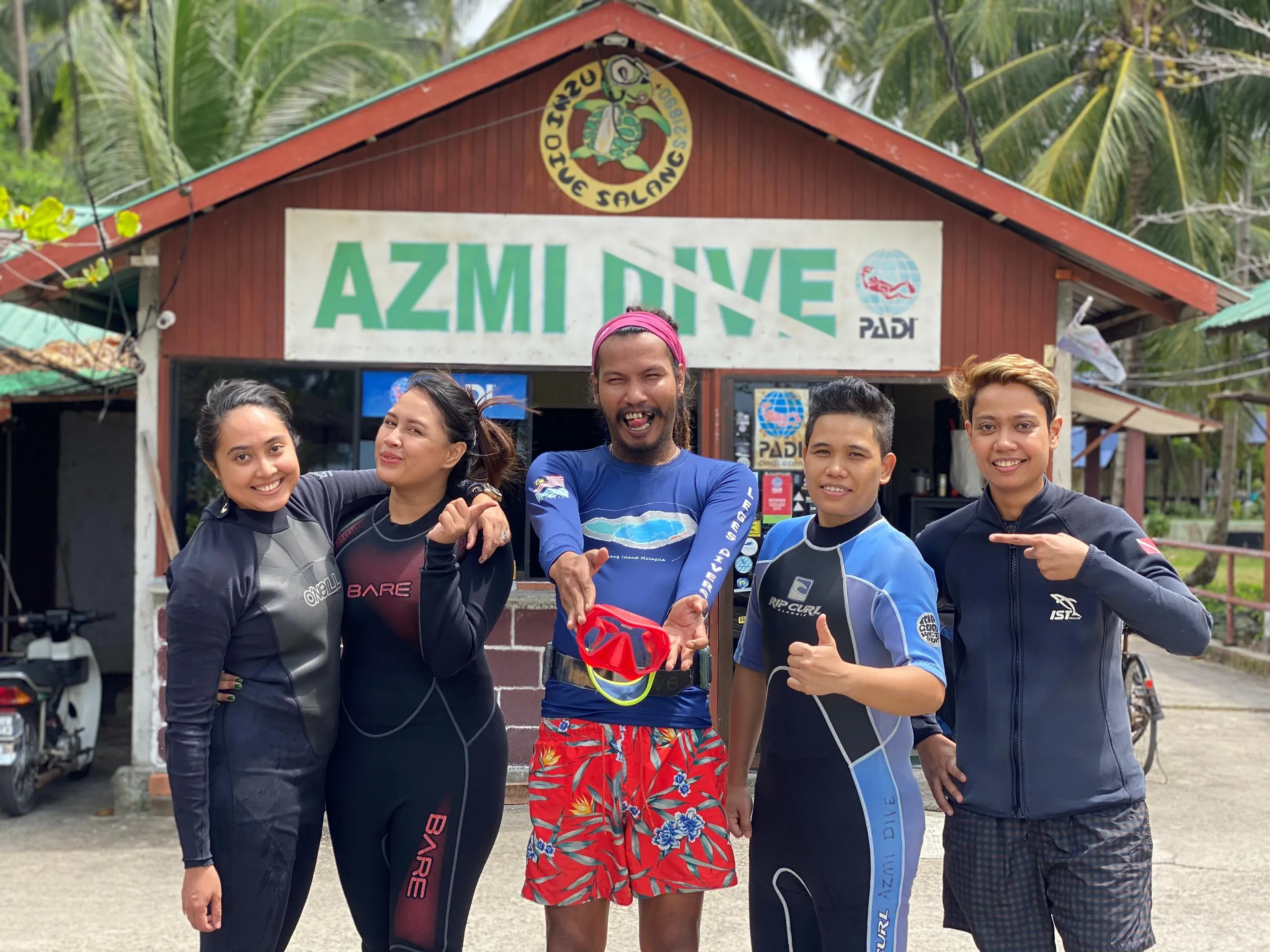 Divers in front of Azmi Dive Centre building