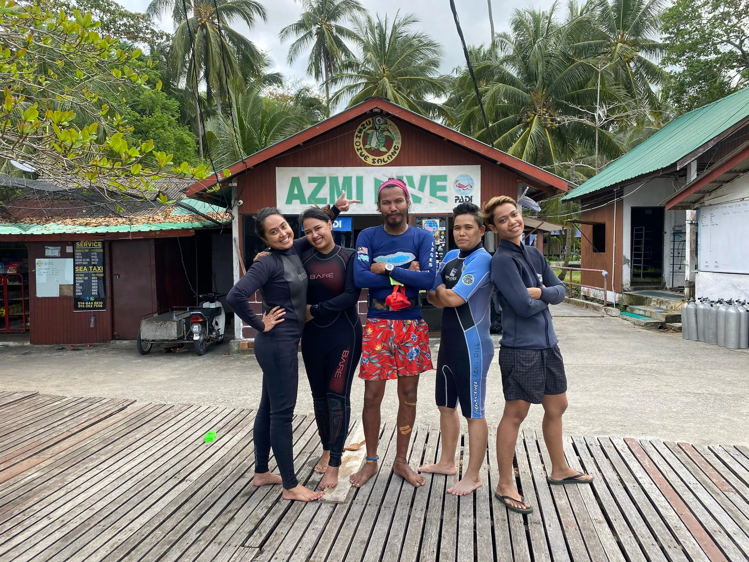Divers standing on deck in front of chalet