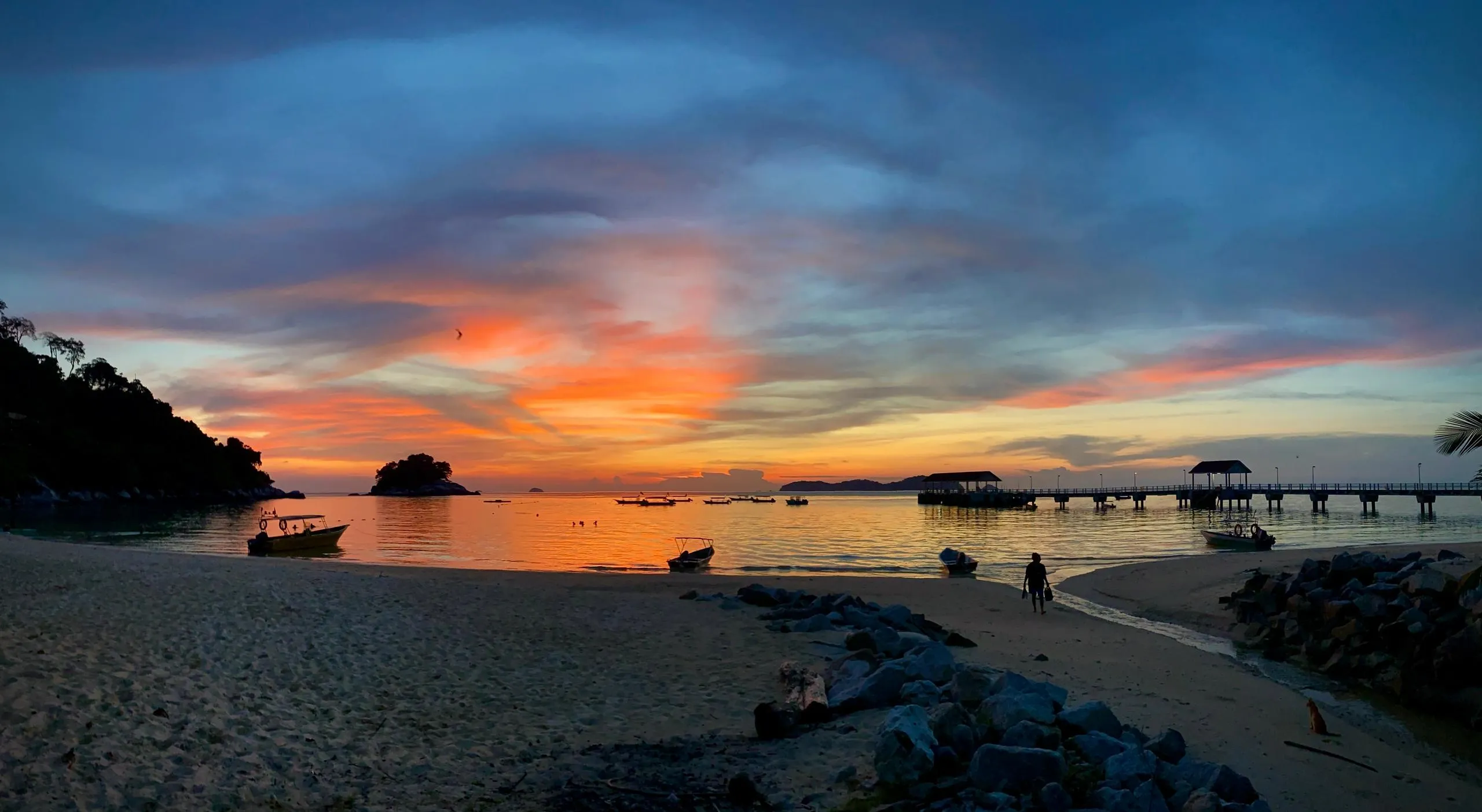 Colorful sunset over sea and boats